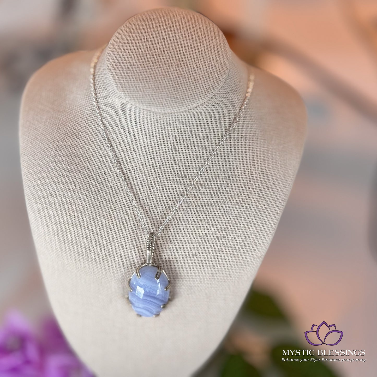 a necklace on a mannequin with flowers in the background