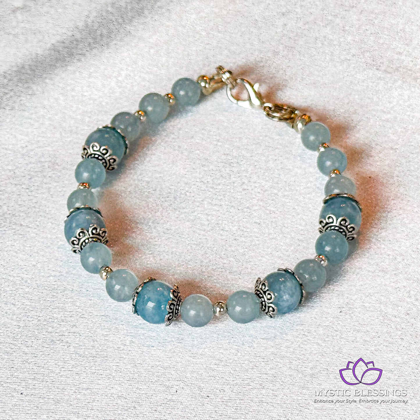 a bracelet with blue beads and a gold clasp