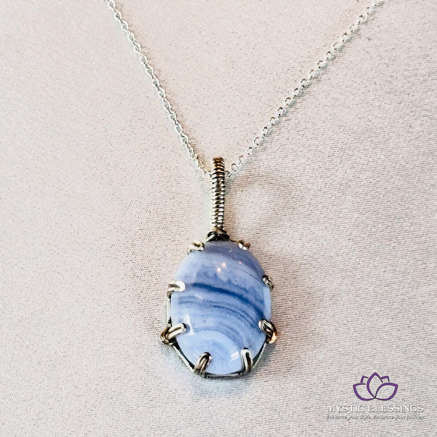 a necklace with a blue glass bead hanging from it