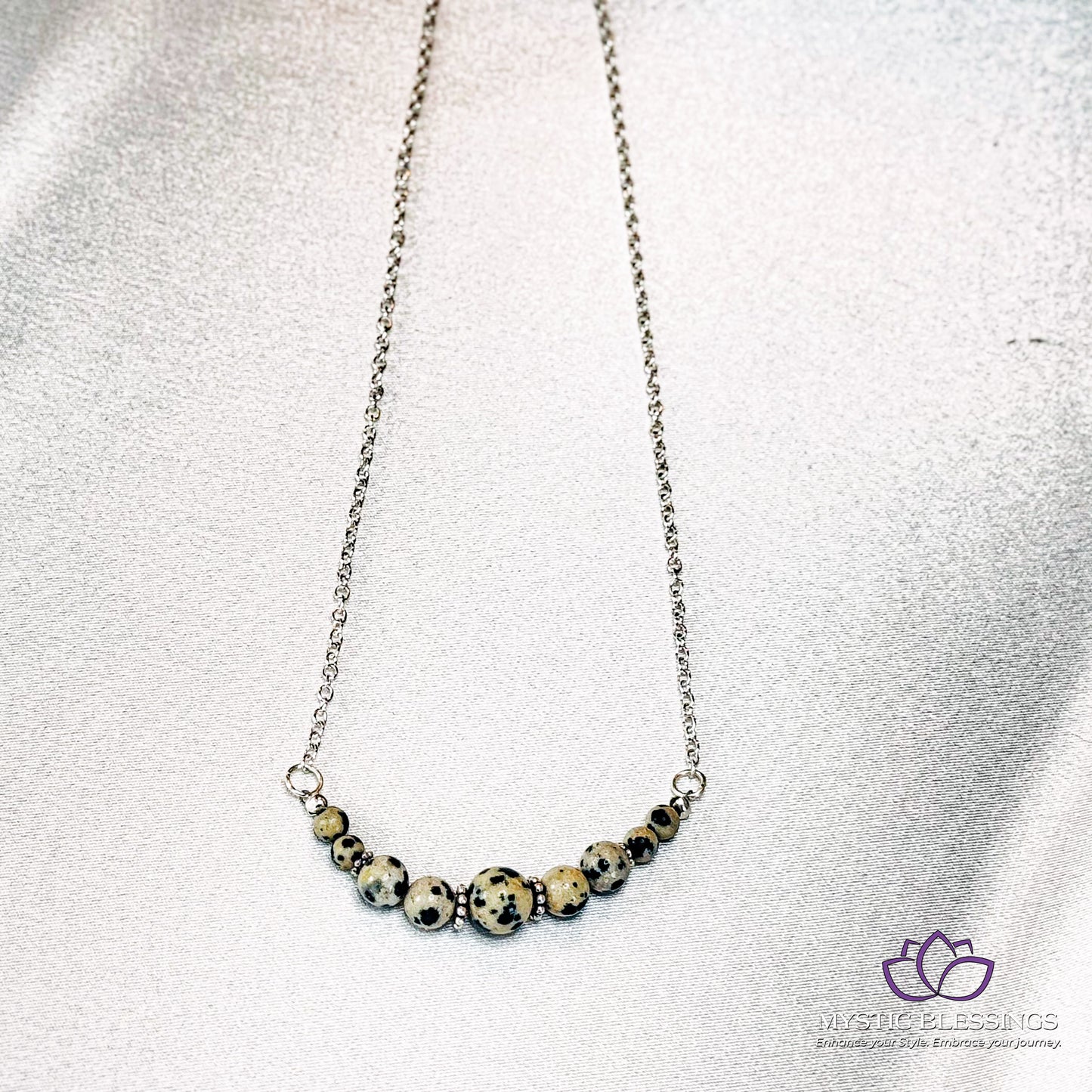 a close up of a necklace on a white surface