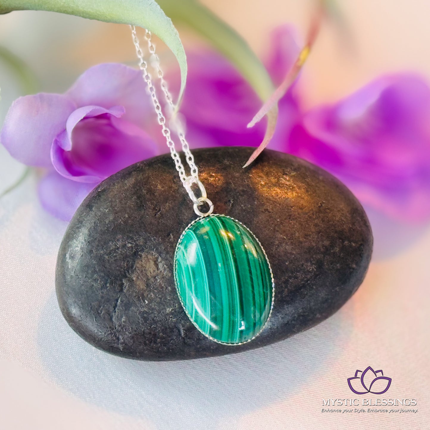 a close up of a necklace on a rock