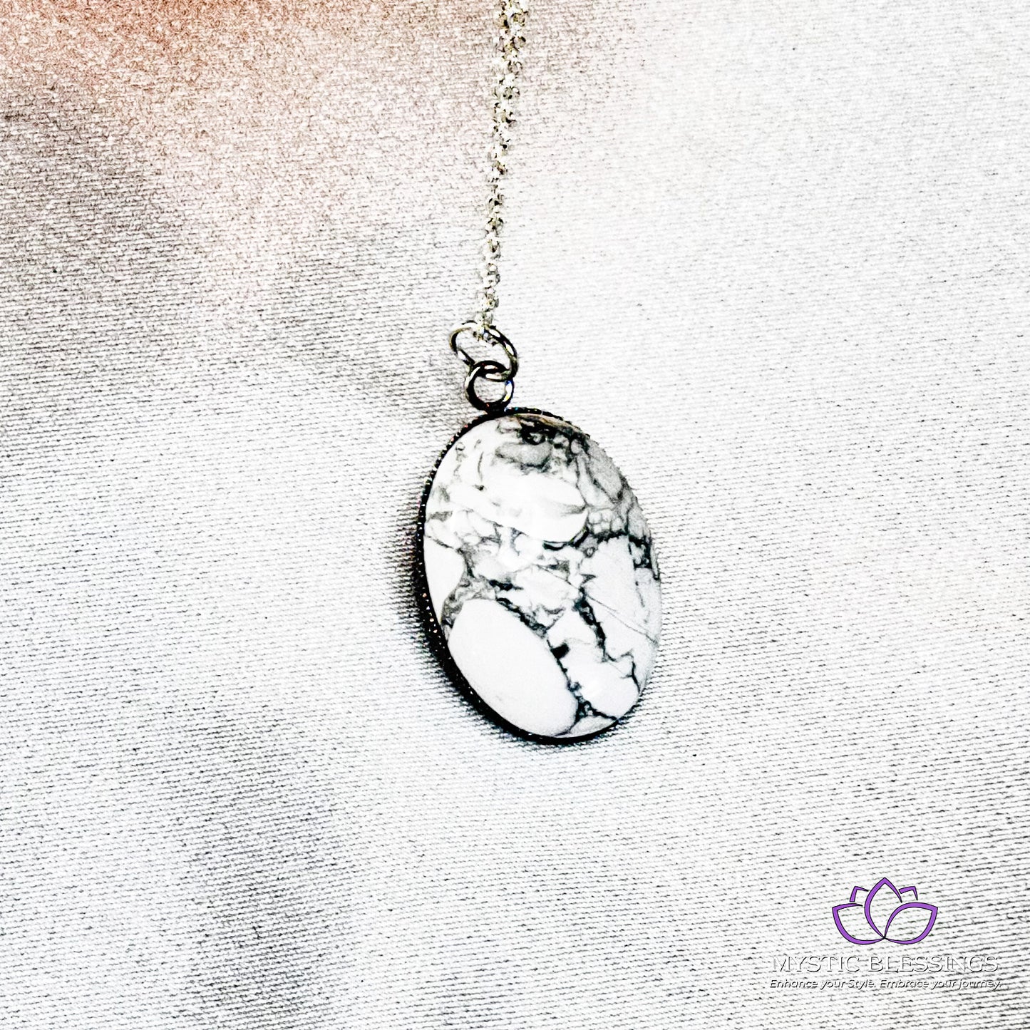 a necklace with a white stone on a chain