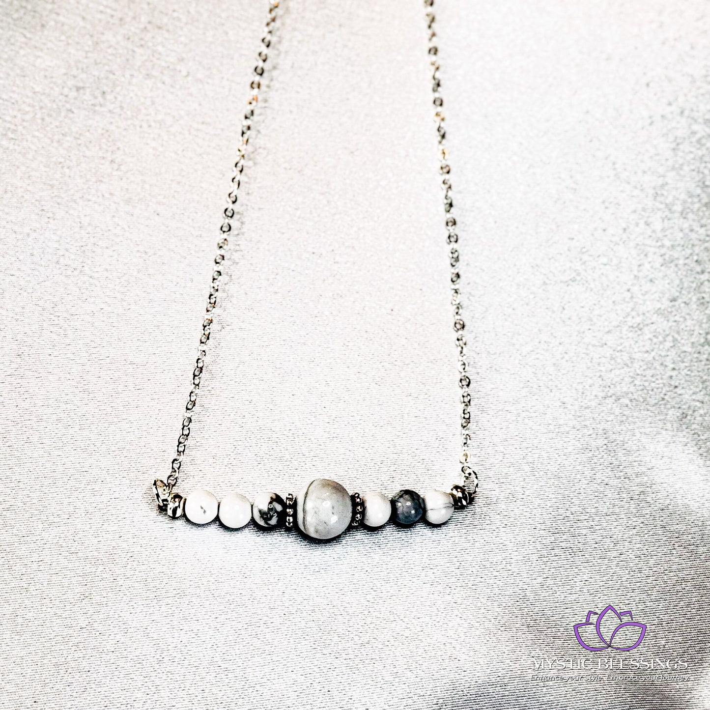 a close up of a necklace on a white surface