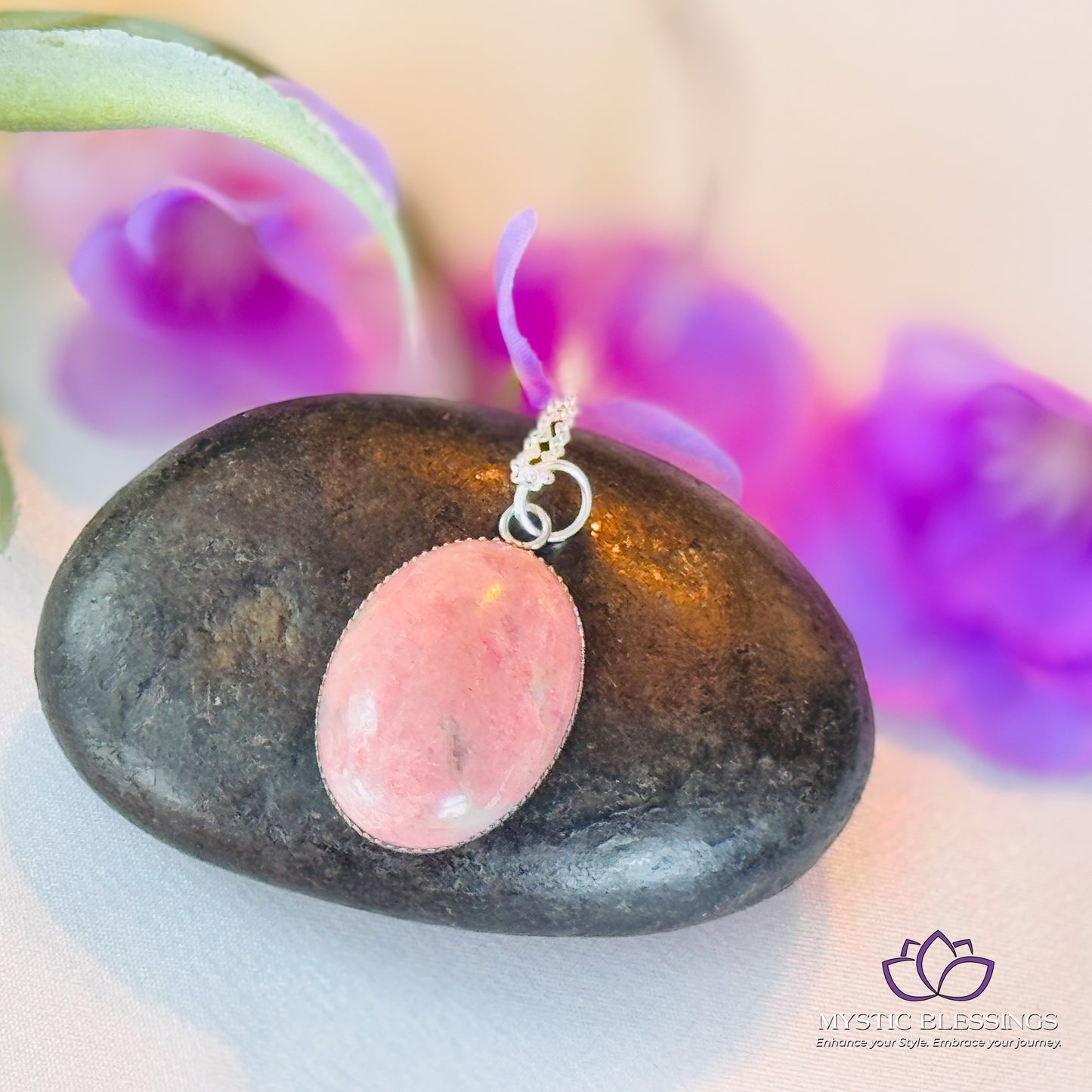 a pink stone sitting on top of a black rock