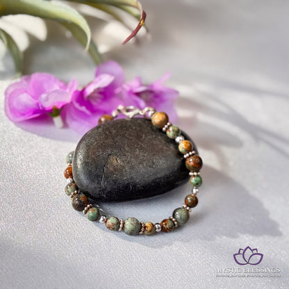 a rock and some flowers on a table