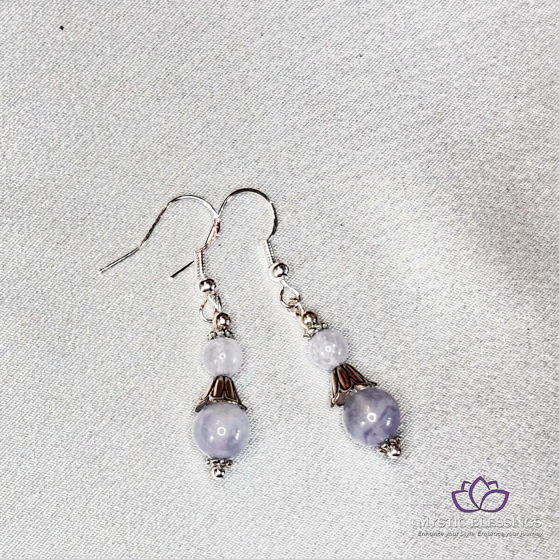 a pair of earrings on a white surface