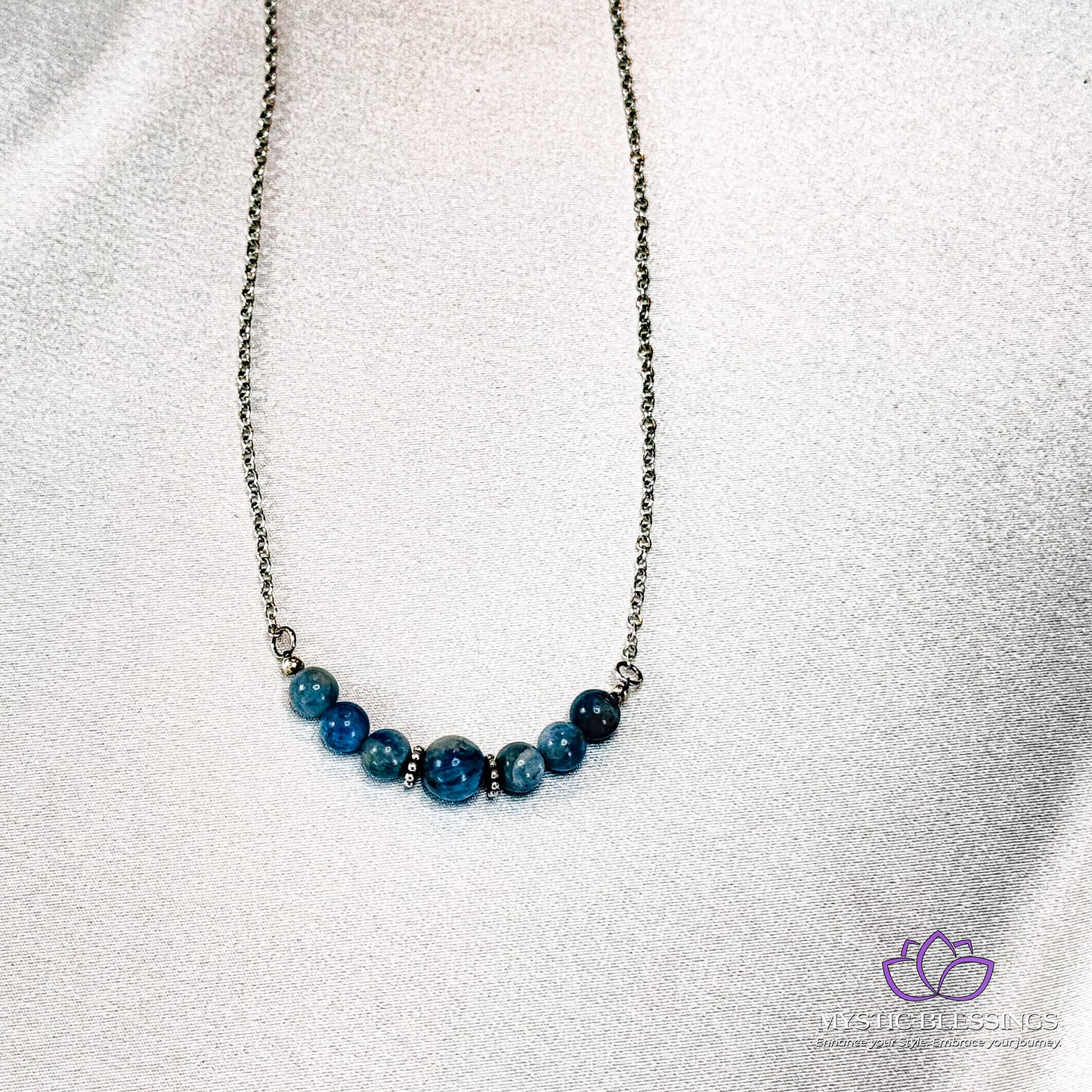 a blue beaded necklace on a silver chain