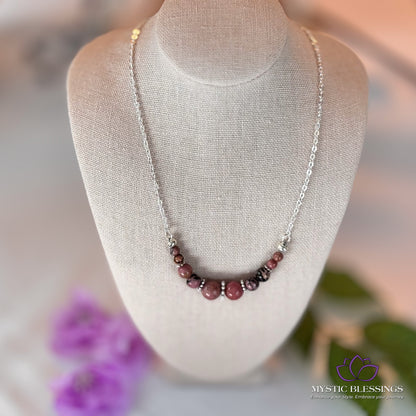 a necklace on a mannequin with flowers in the background