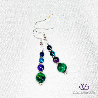 a pair of earrings with multi colored beads