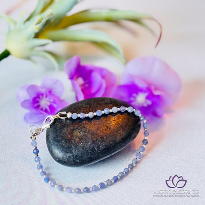 a close up of a rock and a beaded necklace