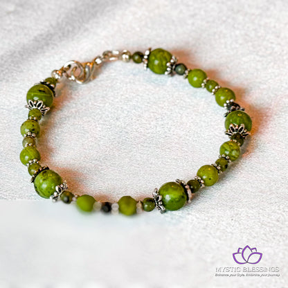 a green beaded bracelet on a white background